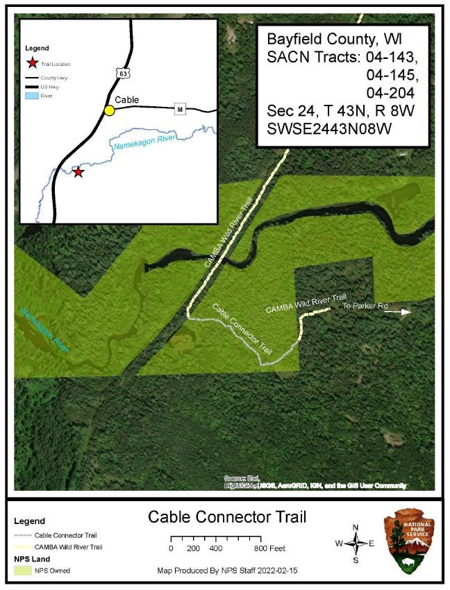 Aerial map image of a green forest. White lettering and lines over the tops of green trees.