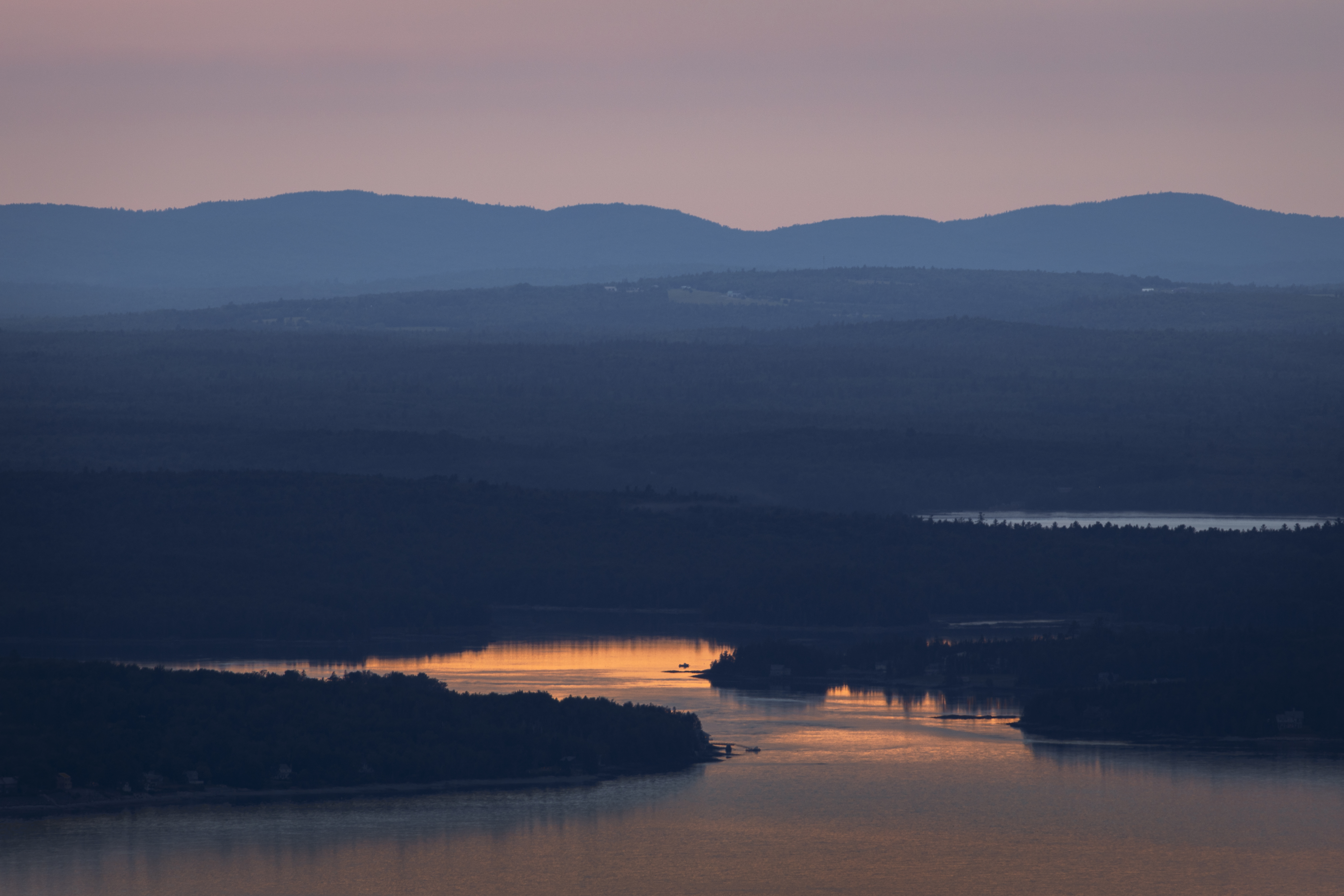 The setting sun over Downeast Maine National Heritage Area from a distance.
