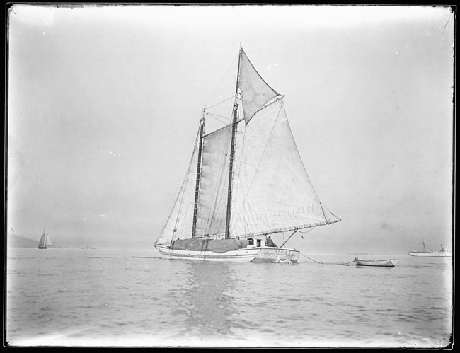 black and white photo of the scow schooner alma carrying bales of hay on San Francisco Bay.