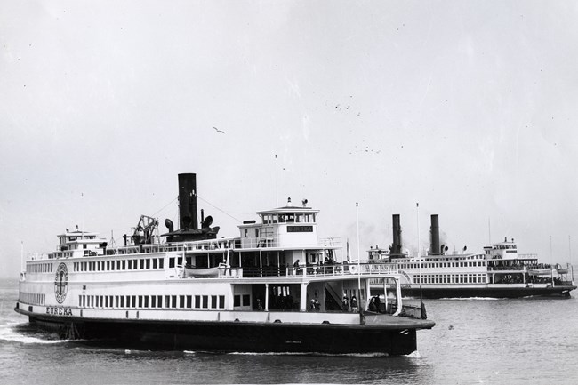 Two large white ferry boats on the Bay