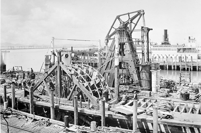 Historical photograph of the walking beam steam engine during the reconstruction of the ferryboat Eureka