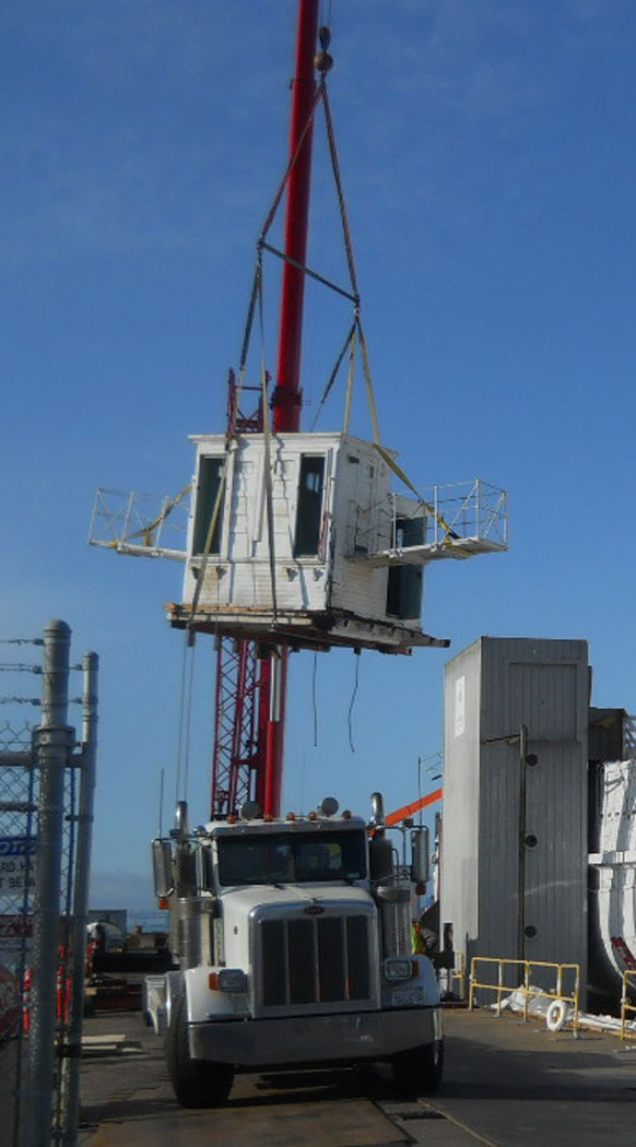 The pilothouse being lowered onto a truck.