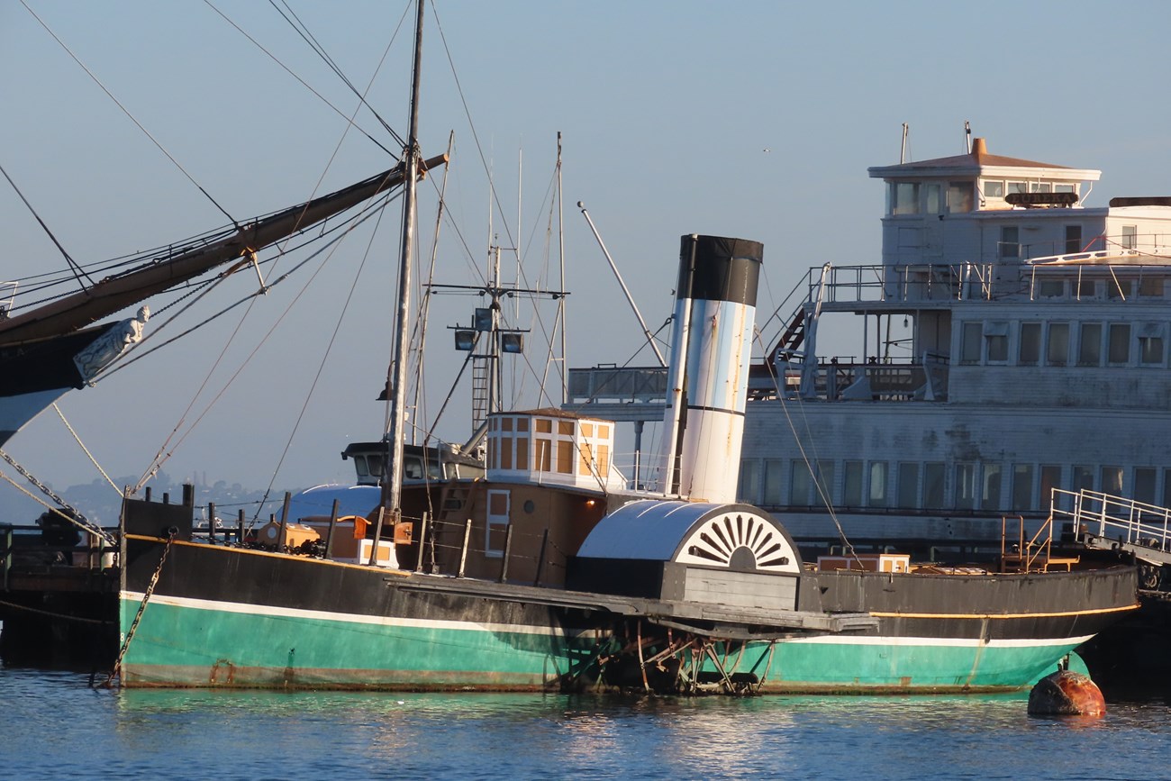 the steam-tug Eppleton Hall is docked to Hyde Street Pier illuminated by soft morning light