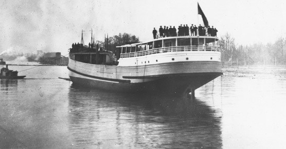 A large, wooden steam schooner floating in the water in 1915.