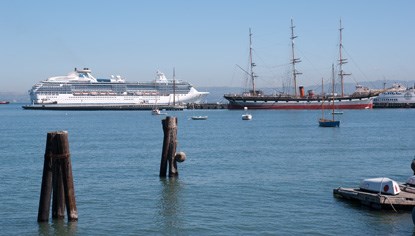 A modern-day cruise ship passing BALCLUTHA moored at Hyde Street Pier.