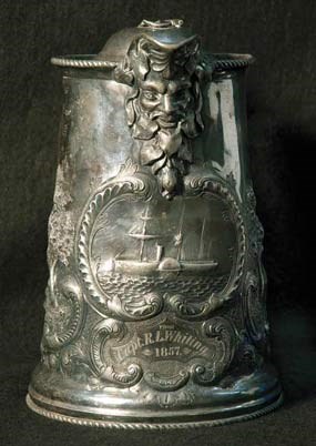 A front view of a silver pitcher.
