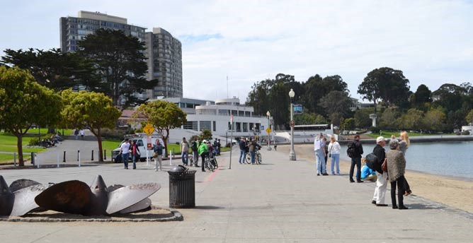 The Aquatic Park promenade, beach and cove. The Maritime Museum is in the background.
