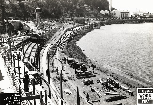 Historic photo from 1938 of Aquatic Park construction in progress along the curve of the cove's shoreline.