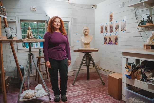 sculptor standing in studio