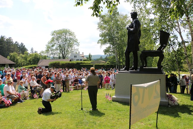 group gathered in front of sculpture