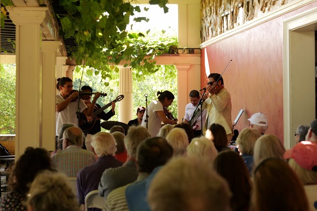 fiddling group perform on pergola