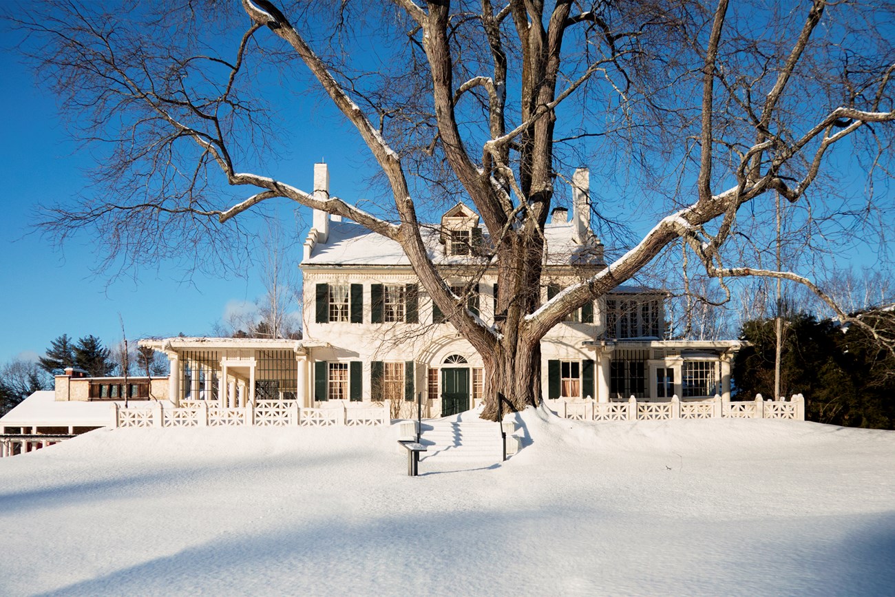 white brick home surrounded with snow