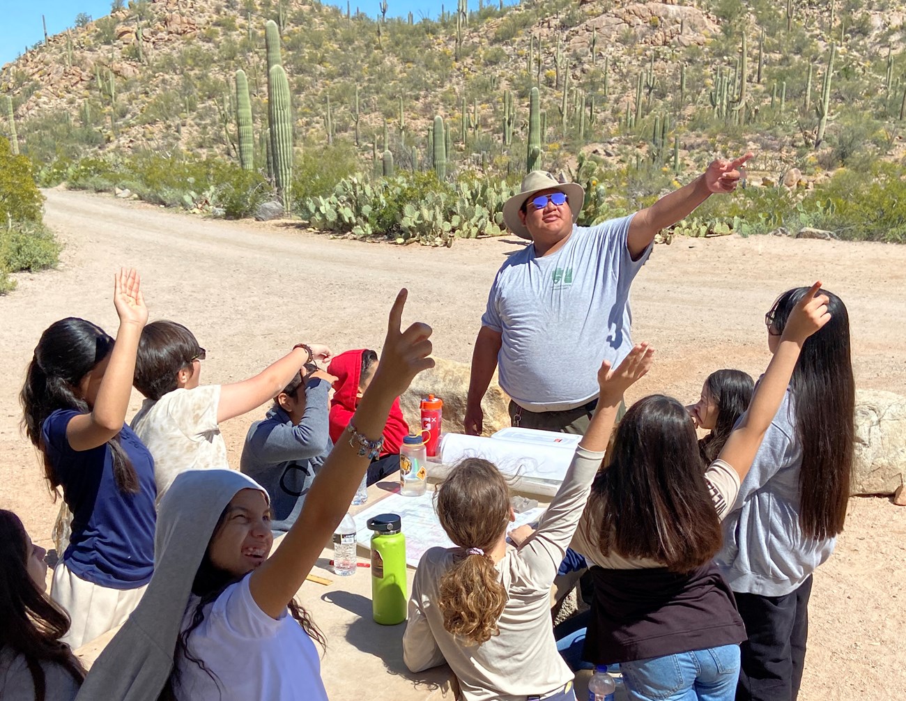kids and ranger pointing into the sky