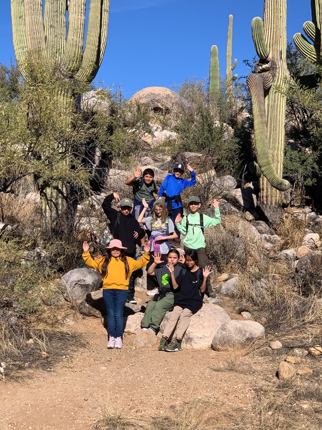kids with arms out in "saguaro pose"
