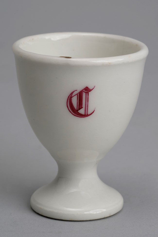 White egg cup with red C