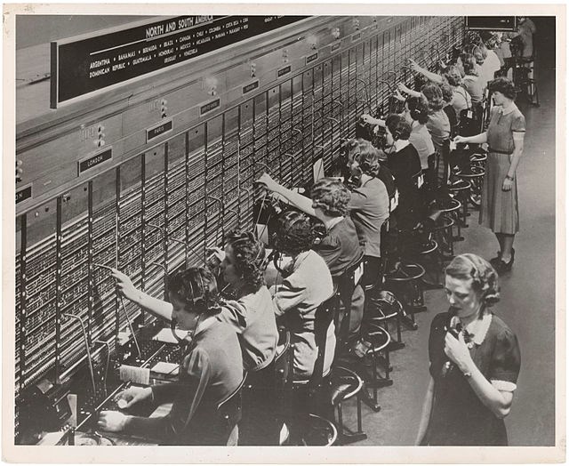 black and white photograph of women working at a switchboard