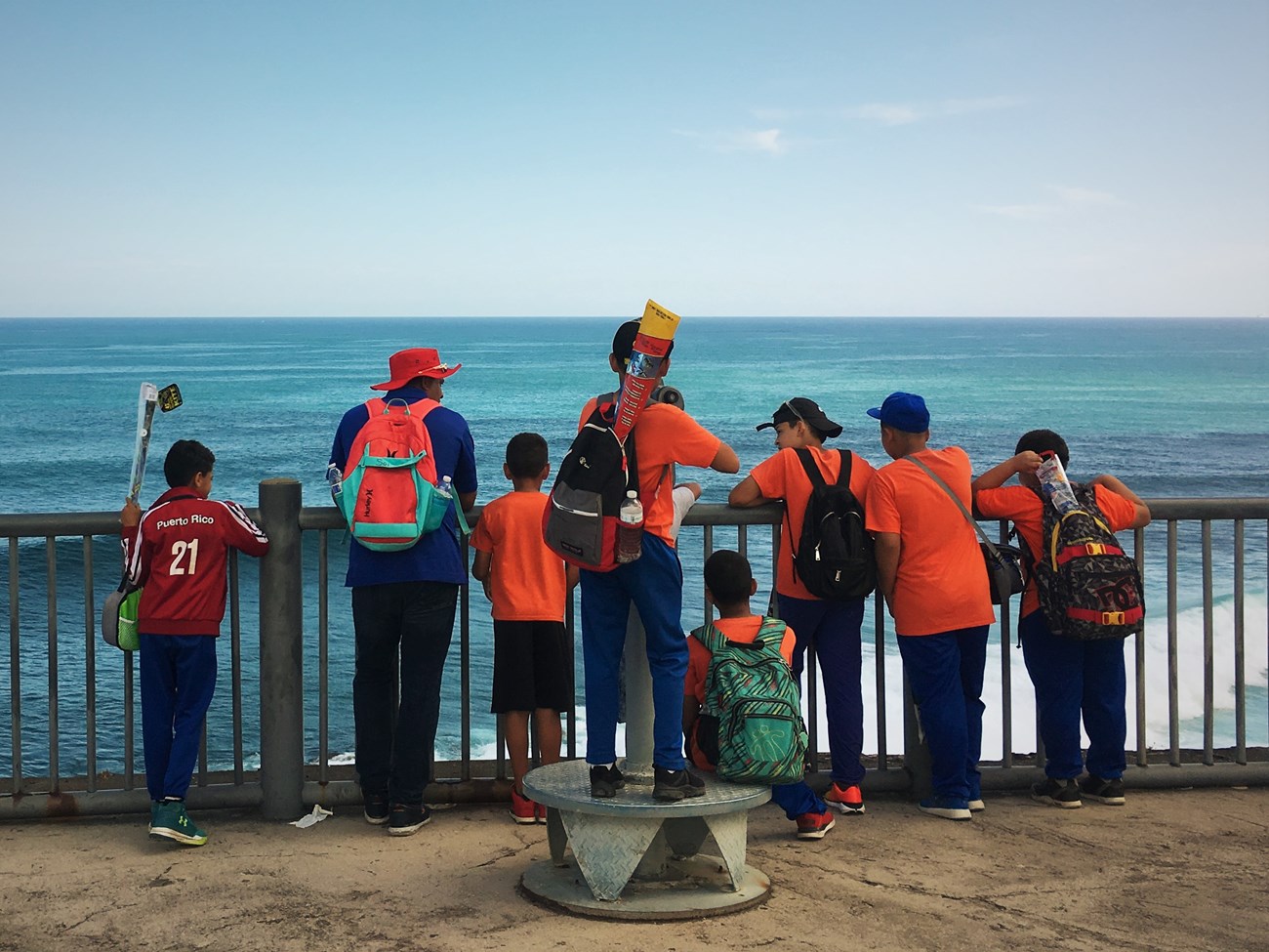 A group of students and their teacher stare into the ocean from El Morro 4th Level
