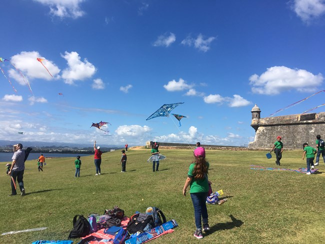 Students fly their kites at El Morro Esplanade.