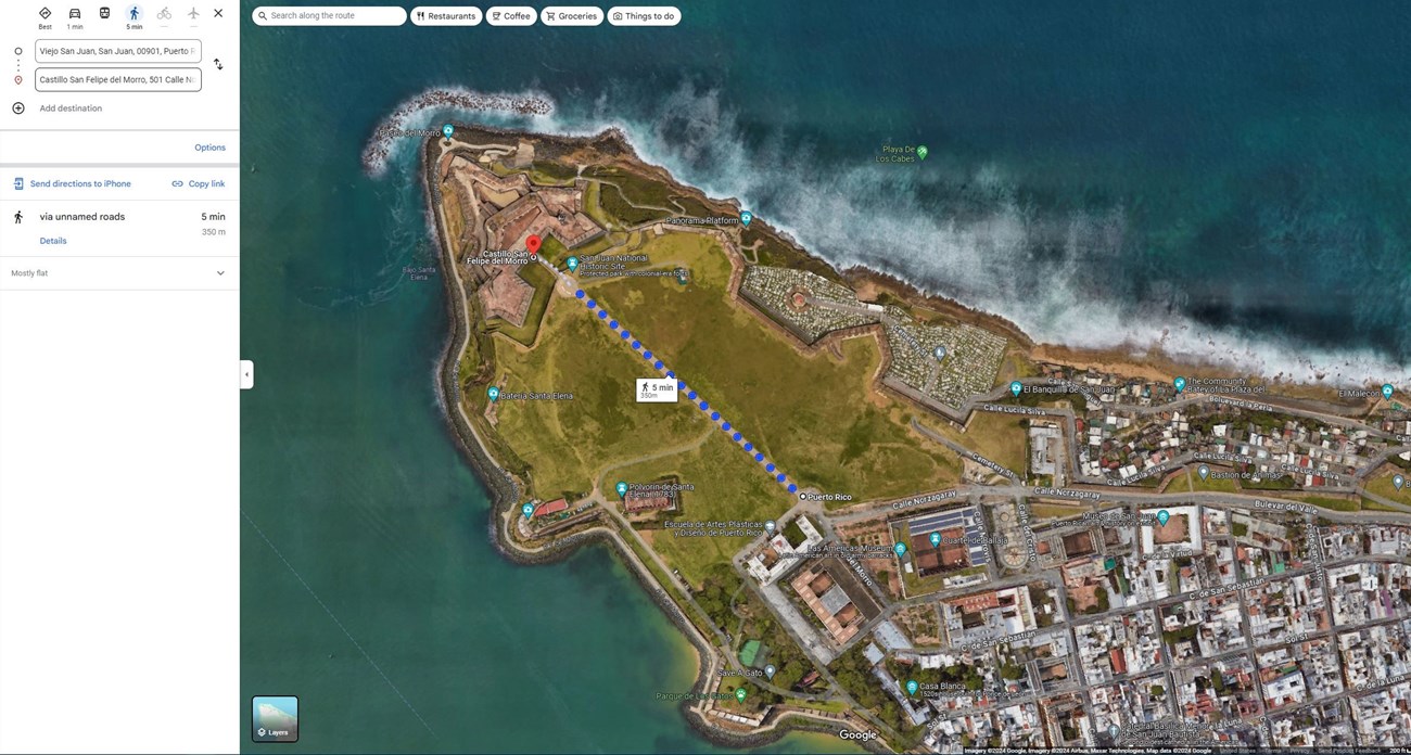 Bird's-eye view of a map of Castillo San Felipe del Morro and Old San Juan with blue dots showing the directions from the hailride pick-up/drop-off point to Castillo San Felipe del Morro's entrance.