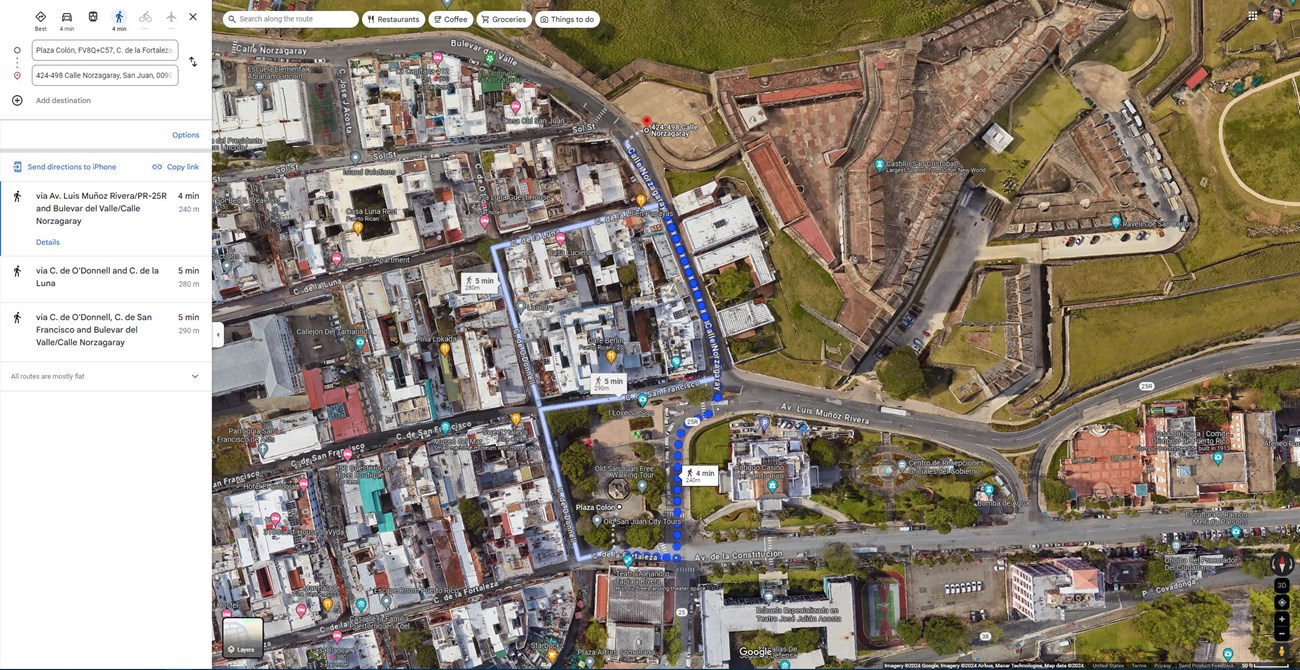 Bird's-eye view of a map of Castillo San Cristobal and Old San Juan with blue dots explaining the directions to walk from the ridehailing pick-up/drop-off location to Castillo San Cristobal.