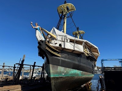 A large wooden ship being hauled out of the water