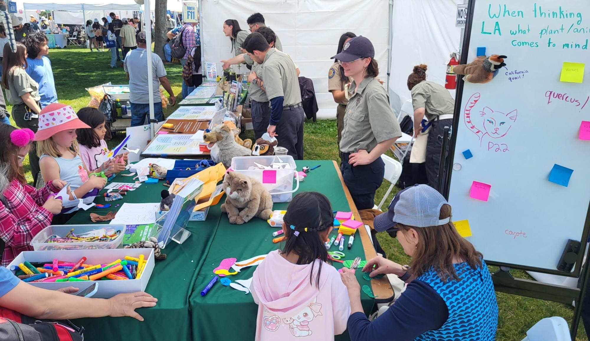 EKO Education Guides leading an interactive activity at a tabling event with students and parents gathered around the table.