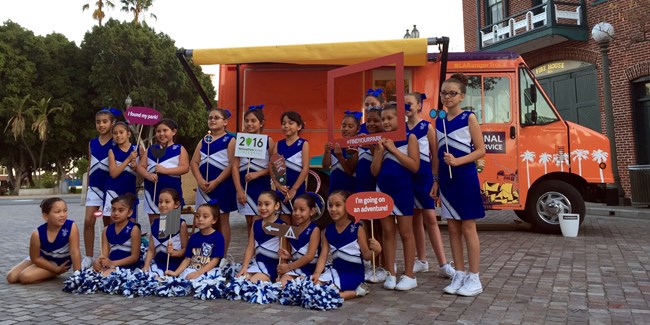 Cheerleading squad posing in front of the LA Ranger Troca.