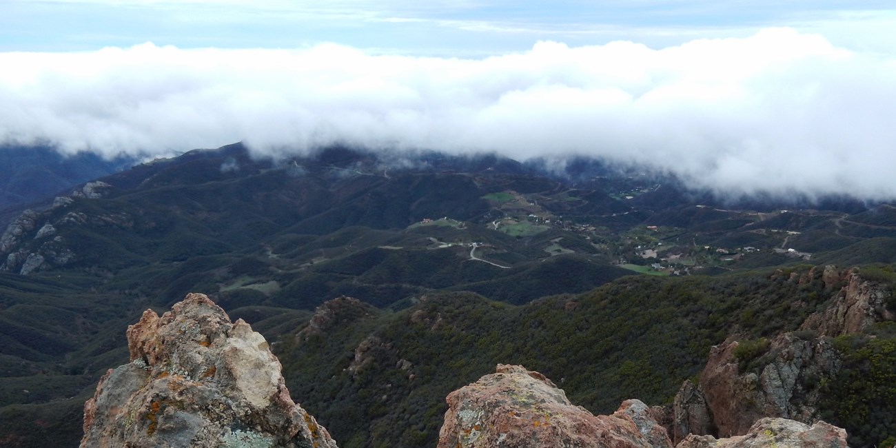The Backbone Trail can provide views of green mountains high above costal fog.