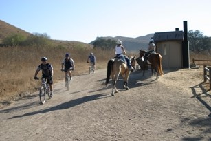 Equestrians and Bicyclists yield to one another on a trail in Cheeseboro.
