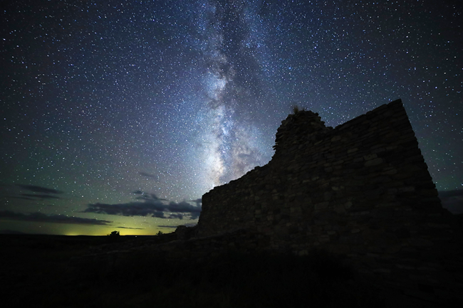 Milky Way visible amongst stars with darkened church remnants in the foreground.