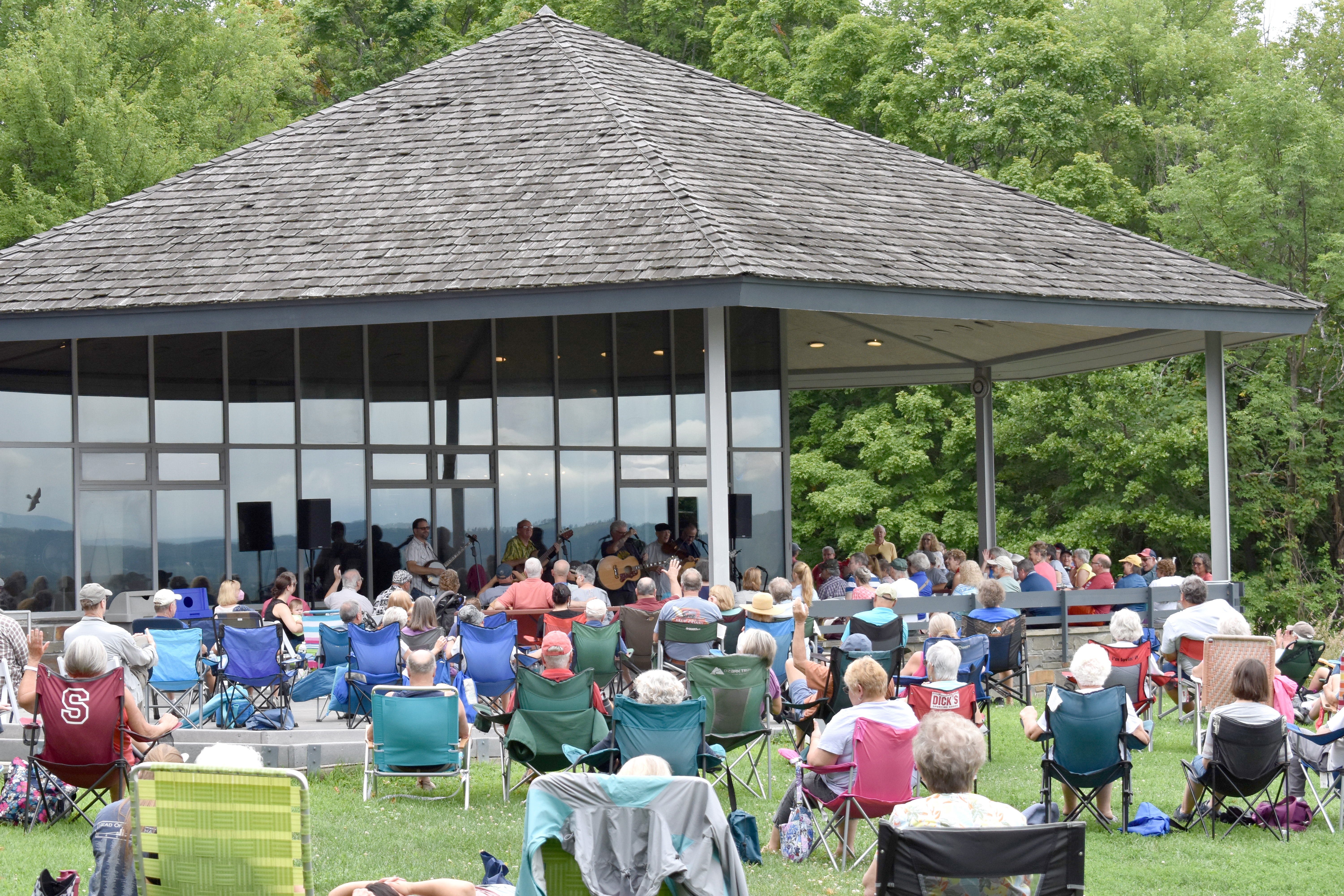 A crowd enjoys a concert in front of the visitor center