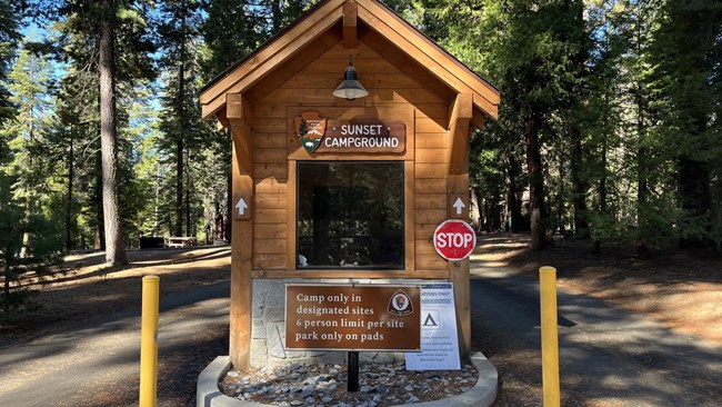 A sign of a campground kiosk titled Sunset.