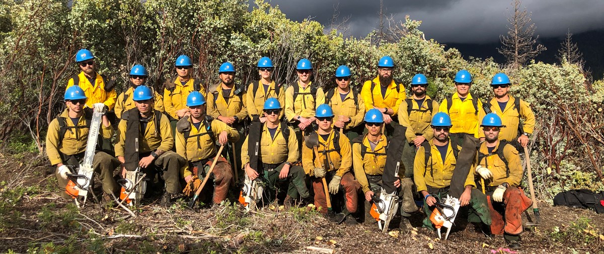 19 Arrowhead Hotshots pose in two rows for a crew photo