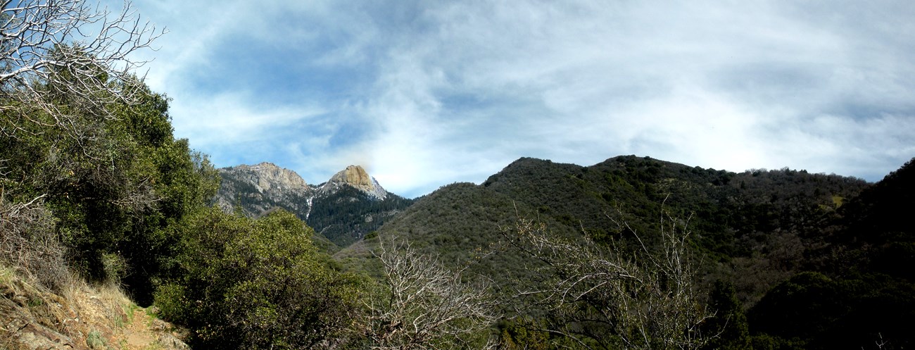 a panorama view of a river and foothills