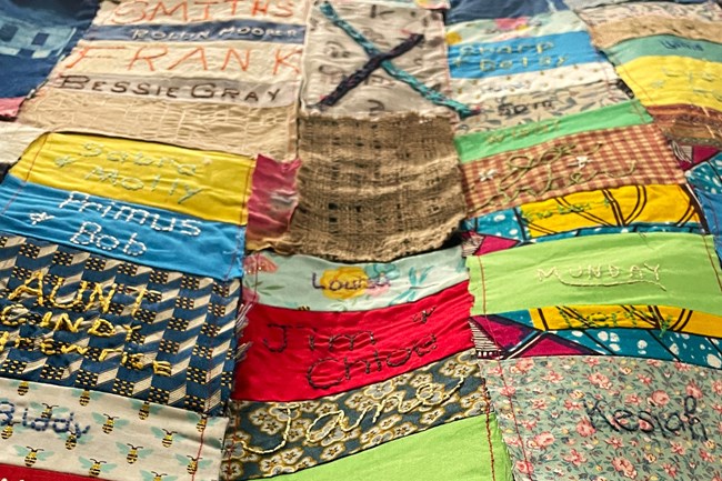 A colorful quilt stitched with names.