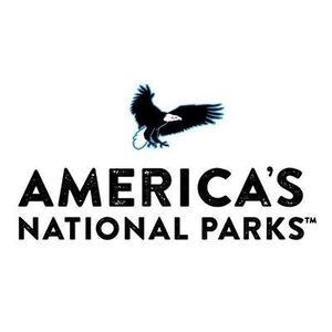 A depiction of a bald eagle in flight over the words "America's National Parks." America's