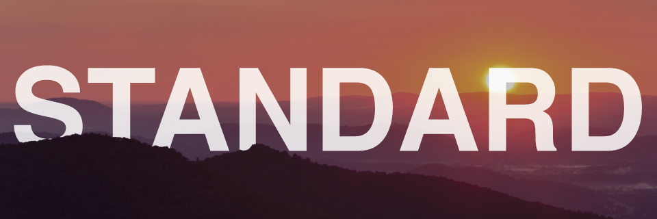 A mountain layer in the foreground with a bright orange sunrise behind. Large, white text reads Standard over of the image.