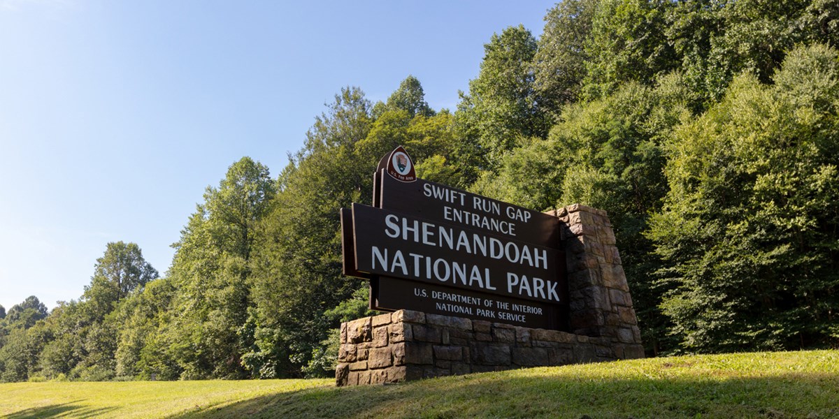 A brown sign reads Swift Run Gap Entrance Shenandoah National Park