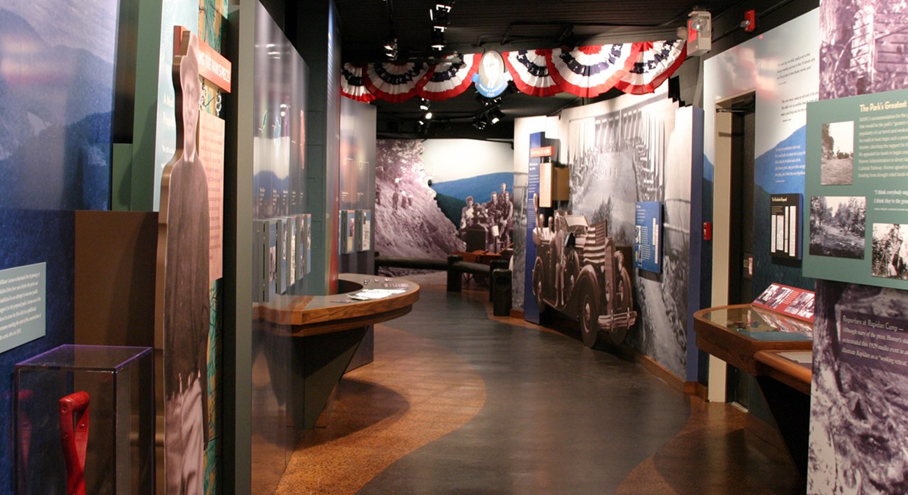 An interior exhibit with signs and artifacts about the establishment of Shenandoah National Park.