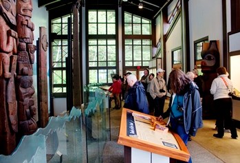 Photo of people viewing totems and museum displays inside Sitka National Historical Park's visitor center