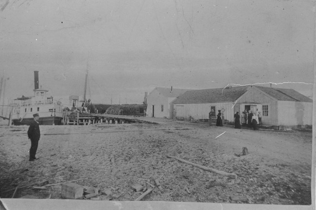 Happy residents of South Manitou Island prepare for a dance in one of the village buildings near the dock.