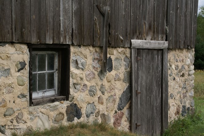 Stone foundation with wooden door and window
