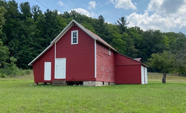 Red outbuilding with white doors