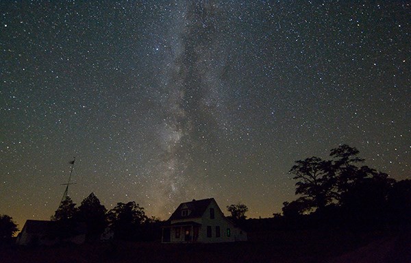 The Milky Way glows over North Manitou Island viilage