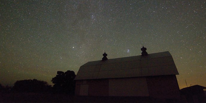 The Milky Way glows over a North Manitou Island Barn