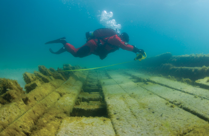 Scuba divers swimming over shipwreck