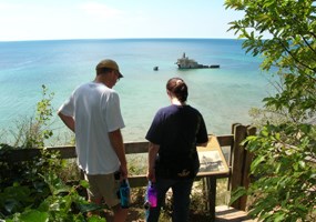 Hikers looking at Morazan shipwreck on SMI