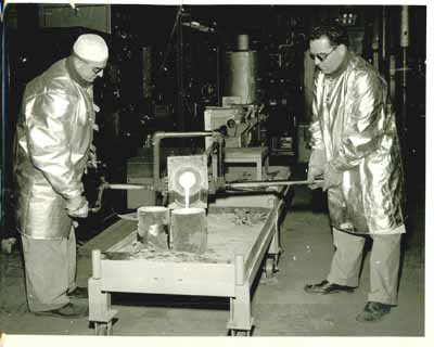 Pouring hot molten steel into molds