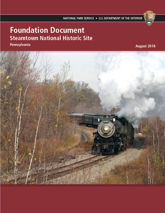 Cover page of Steamtown National Historic Site's Foundation Document. Image shows a train moving on the tracks with trees along the edge