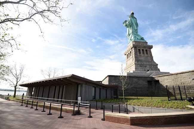 Back of the statue of liberty with building on the side